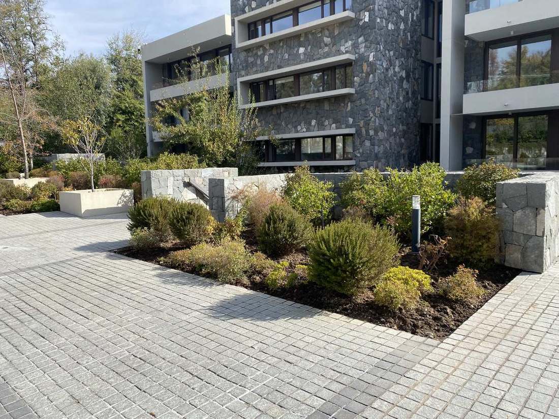 Áreas verdes frente a un edificio de departamentos en Las Condes